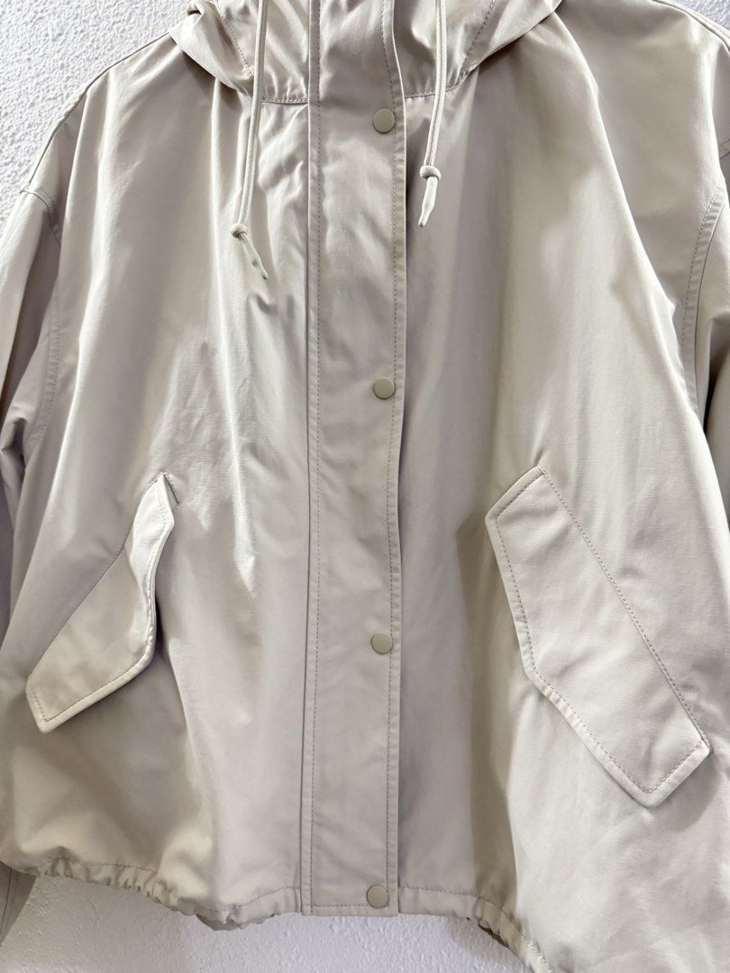 Uniqlo Beige Hooded Jacket with Drawstring (Category: Coats, Jackets and Outerwear) located in Manila. Submitted by janelica220598 (Listing ID 1462896729, Image 2). Description: USED ONCE ONLY BOUGHT FOR 2999 - Lightweight beige jacket - Features a hood with drawstring - Button-up front closure - Two front pockets - Drawstring at the hem - Ideal for casual outings and layering.