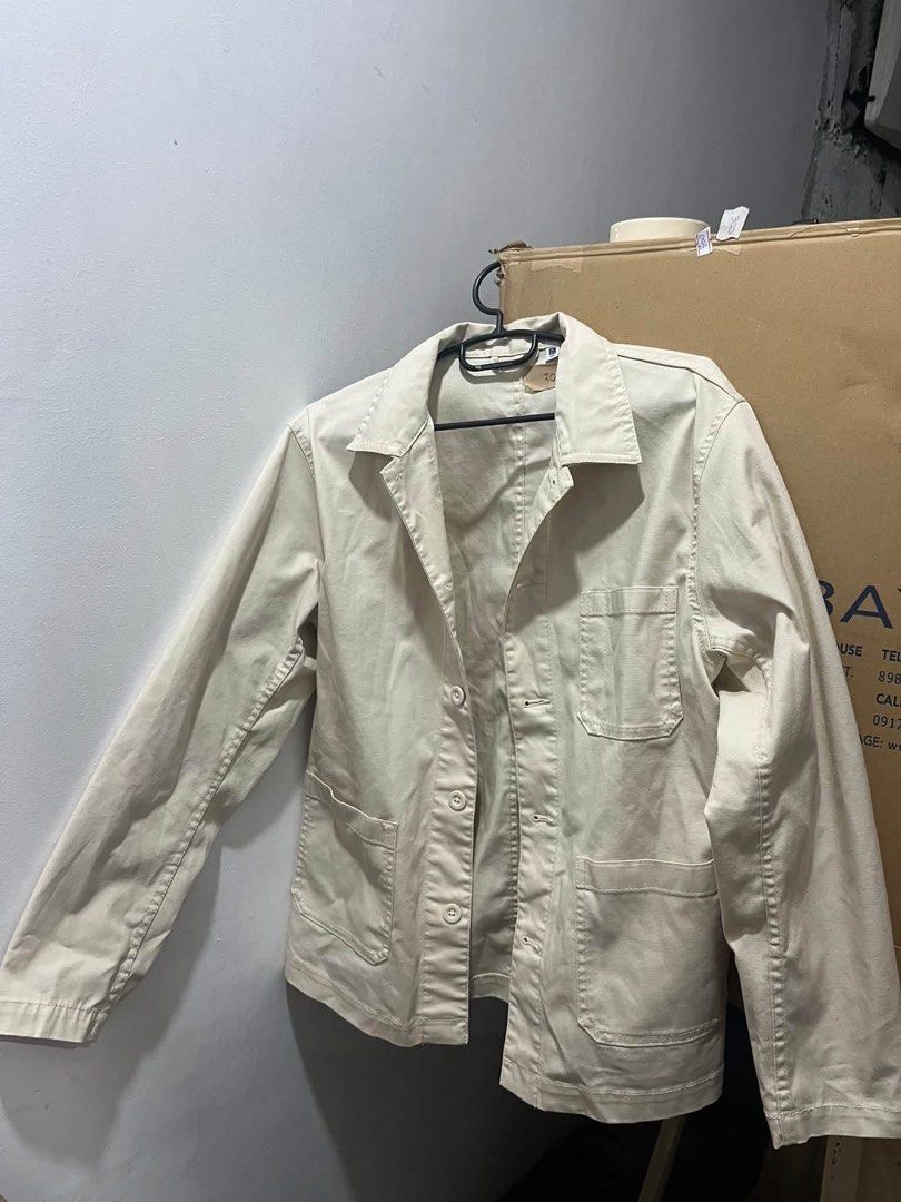 Uniqlo Beige Work Jacket (Category: Coats, Jackets and Outerwear) located in Quezon City. Submitted by decluttercollection01 (Listing ID 1463076309, Image 1). Description: - Uniqlo work jacket in a versatile beige color. - Classic collar and button-up front. - Features two chest pockets and two lower pockets. - Ideal for layering and creating casual outfits. - Selling for PHP 300..
