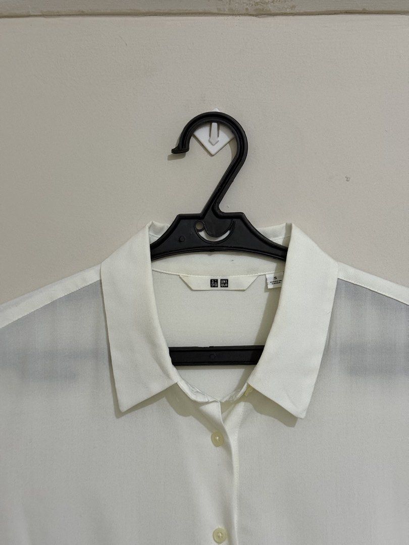 Uniqlo White Rayon Blouse (Category: Blouses) located in San Pedro. Submitted by itsminaxvii (Listing ID 1463020612, Image 2). Description: - Classic white short sleeve shirt from Uniqlo - Simple button-up style - Lightweight material, perfect for layering or wearing solo.