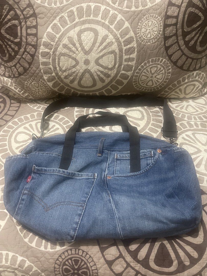 Unique Denim Duffle Bag with Pockets (Category: Cross-body Bags) located in Pasig City. Submitted by cheribomb85 (Listing ID 1462907993, Image 1). Description: - Cool denim duffle bag - Features front jean back pockets - Ample interior space for essentials - Includes both shoulder strap and handles - Ideal for travel or everyday carry.