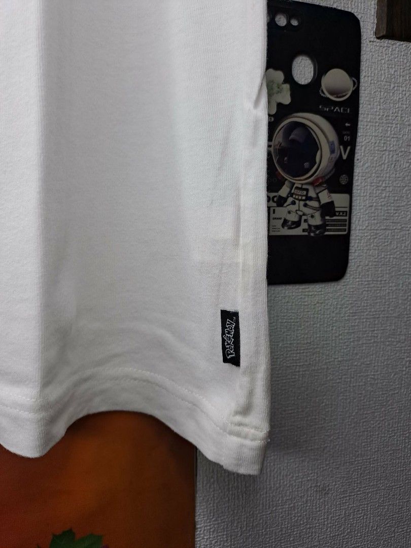 UT Uniqlo x Pikachu x Pokèmon (Category: Shirts) located in Manila. Submitted by yaseen__73 (Listing ID 1463058588, Image 3). Description: "With Pokémon" UT collection by UNIQLO. Released as part of a 2020 collaborative capsule, the shirt features a minimalist line-art design outlining the back silhouette of a female Pikachu (identifiable by the heart-shaped notch at the end of its lightning-bolt tail). - Small on Tag - Dimensions : See Photo - C