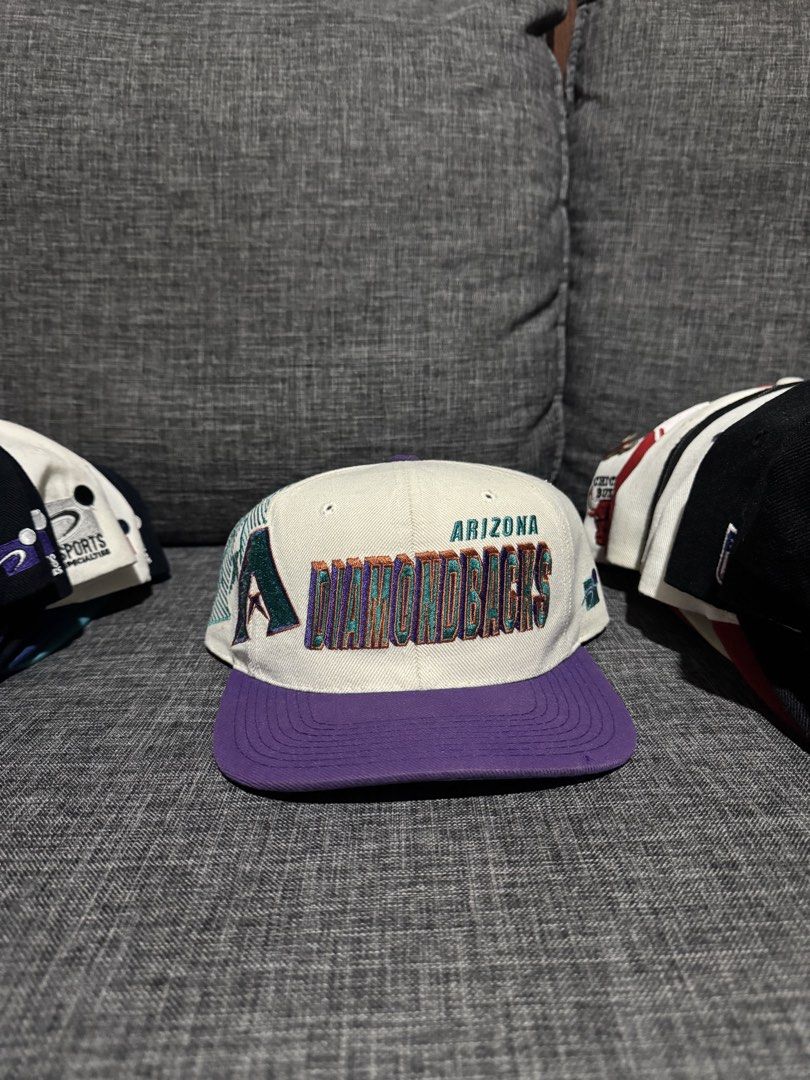 Vintage Arizona Diamondbacks Shadow Cap (Category: Caps & Hats) located in Solano. Submitted by Hustle.Everyday (Listing ID 1463038148, Image 1). Description: - Arizona Diamondbacks snapback cap - Features team name embroidered on the front - Classic 'A' logo on the side - Stylish purple brim and white crown - Adjustable snap for a custom fit - Perfect for any Diamondbacks fan!.