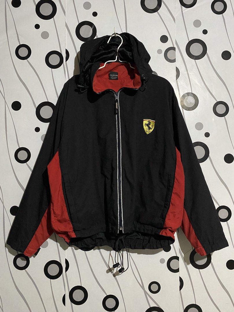 Vintage Ferrari windbreaker jacket (Category: Coats, Jackets and Outerwear) located in Cebu City. Submitted by patspickph (Listing ID 1462905663, Image 1). Description: This is a vintage Ferrari windbreaker jacket in black with red side panels. Full-zip windbreaker with a hood and Black body with red accents on the sleeves and sides, plus a red inner lining. Features the iconic yellow Ferrari shield logo on the chest and an adjustable bungee draw