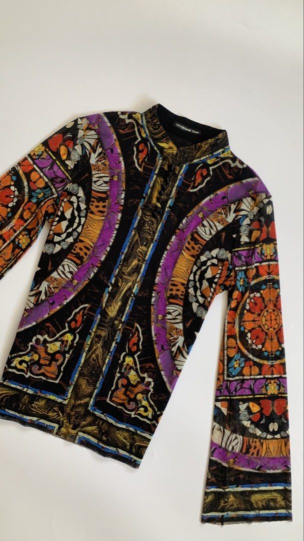 Vivienne Tan Mesh Print Long Sleeve Top (Category: Longsleeves) located in Tarlac. Submitted by luv__vintage (Listing ID 1462902657, Image 3). Description: - Vivienne Tan mesh top - Bold, colorful tiger and floral print - High neckline - Long sleeves - Sheer and lightweight fabric - Ideal for layering or as a standalone statement piece - Fits true to size.