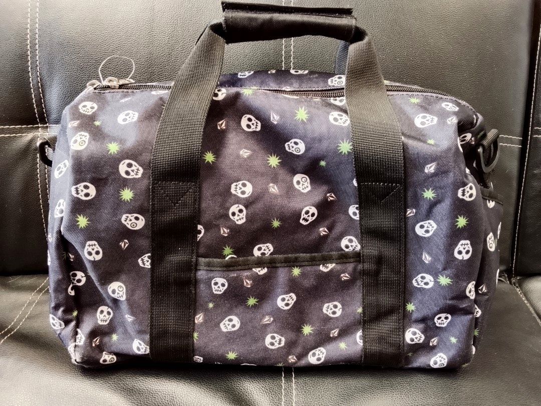 Vintage Volcom skull- print duffle bag (Category: Briefcases) located in Manila. Submitted by newage.vintage (Listing ID 1462898364, Image 2). Description: - retro Volcom logo - dual zipper - multiple pocket on duffle bag - all over print skull print - heavy duty black nylon straps - functionality: travel bag, gym bag, or skate companion - vintage Volcom duffle bag.