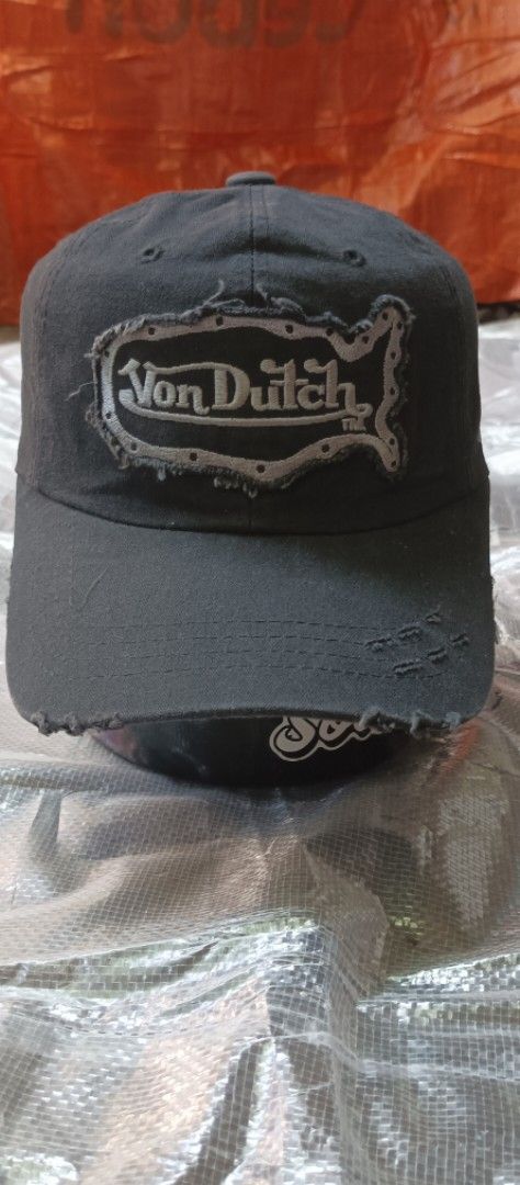 Von Dutch Black Distressed Baseball Cap (Category: Caps & Hats) located in Quezon City. Submitted by mangthrift (Listing ID 1463033590, Image 1). Description: - Black Von Dutch cap - Distressed patch logo on front - Smaller logo detail on the side - Frayed brim and edges for a vintage look - Adjustable strap for a custom fit - Ideal for everyday casual wear.