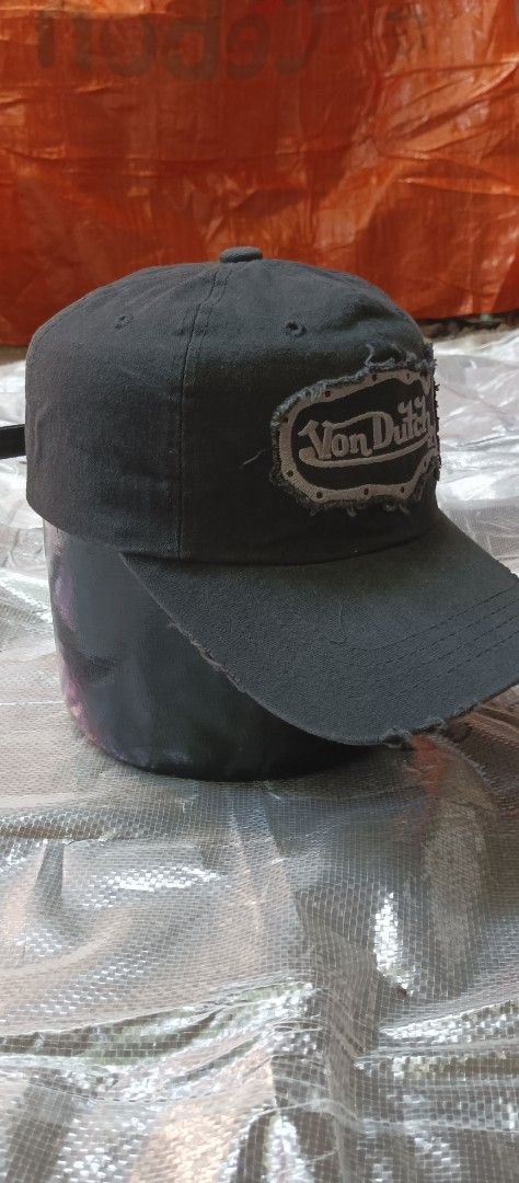 Von Dutch Black Distressed Baseball Cap (Category: Caps & Hats) located in Quezon City. Submitted by mangthrift (Listing ID 1463033590, Image 3). Description: - Black Von Dutch cap - Distressed patch logo on front - Smaller logo detail on the side - Frayed brim and edges for a vintage look - Adjustable strap for a custom fit - Ideal for everyday casual wear.