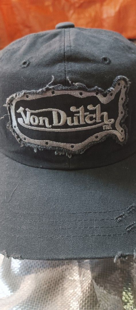 Von Dutch Black Distressed Baseball Cap (Category: Caps & Hats) located in Quezon City. Submitted by mangthrift (Listing ID 1463033590, Image 2). Description: - Black Von Dutch cap - Distressed patch logo on front - Smaller logo detail on the side - Frayed brim and edges for a vintage look - Adjustable strap for a custom fit - Ideal for everyday casual wear.