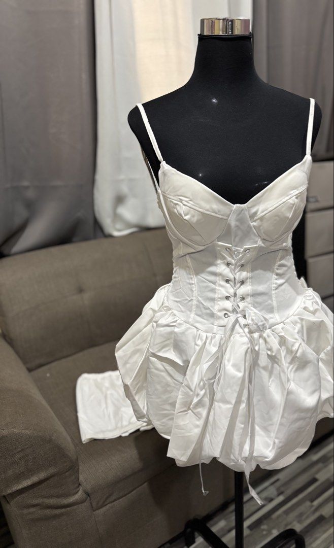 White Corset Bustier Bubble Hem Dress (Category: Dresses) located in Caloocan City. Submitted by niki.niki. (Listing ID 1463051660, Image 1). Description: - Elegant white satin dress - Corset bustier top with front lace-up detail - Flattering bubble hem skirt with adjustable drawstring - Delicate thin spaghetti straps - Ideal for parties, events, and special occasions.