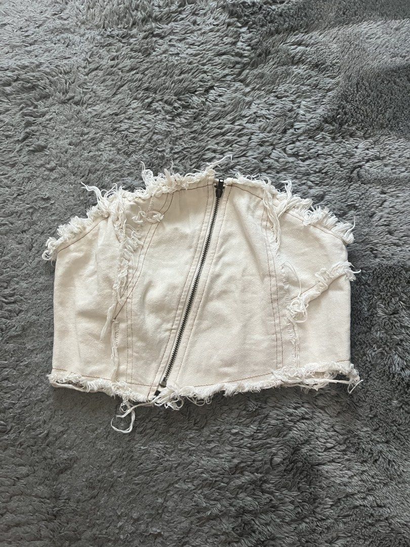 White Distressed Corset Top with Zipper (Category: Others Tops) located in Pasig City. Submitted by thecollective_ (Listing ID 1462890266, Image 1). Description: - White corset top - Distressed, frayed hem - Diagonal zipper closure down the front - Denim or sturdy cotton blend fabric - Ideal for night out or festival looks - Pairs well with high-waisted jeans or skirts.