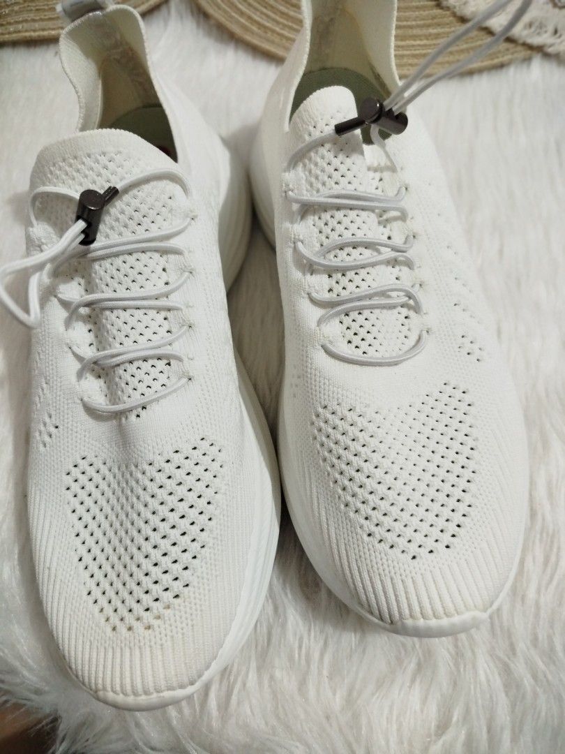 White Knit Sneakers with Elastic Laces (Category: Sneakers) located in Quezon City. Submitted by plus4lessshop (Listing ID 1462918407, Image 1). Description: - White knit sneakers - Easy slip-on style with elastic laces and toggle - Breathable knit upper with perforated details - "MADE IN CHIN" stamped on heel tab - Comfortable and casual design.