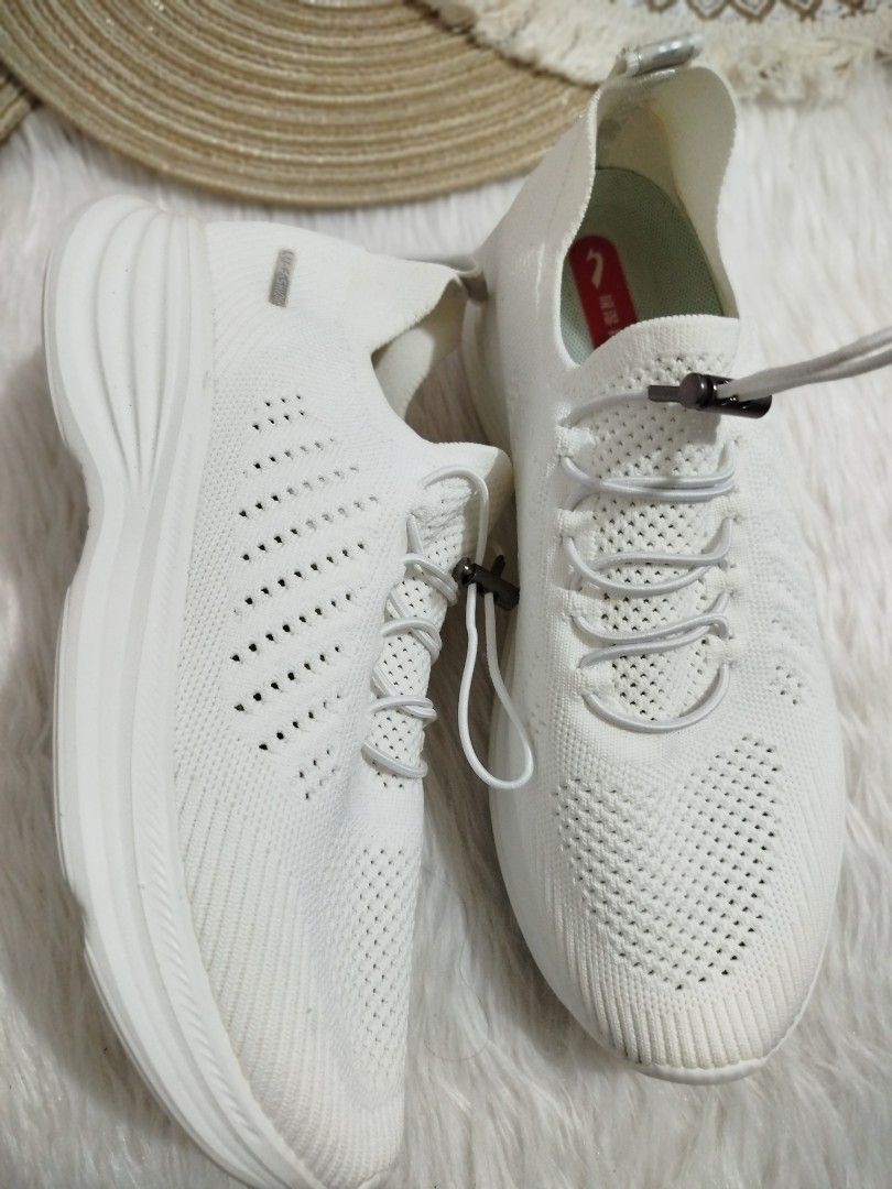 White Knit Sneakers with Elastic Laces (Category: Sneakers) located in Quezon City. Submitted by plus4lessshop (Listing ID 1462918407, Image 2). Description: - White knit sneakers - Easy slip-on style with elastic laces and toggle - Breathable knit upper with perforated details - "MADE IN CHIN" stamped on heel tab - Comfortable and casual design.