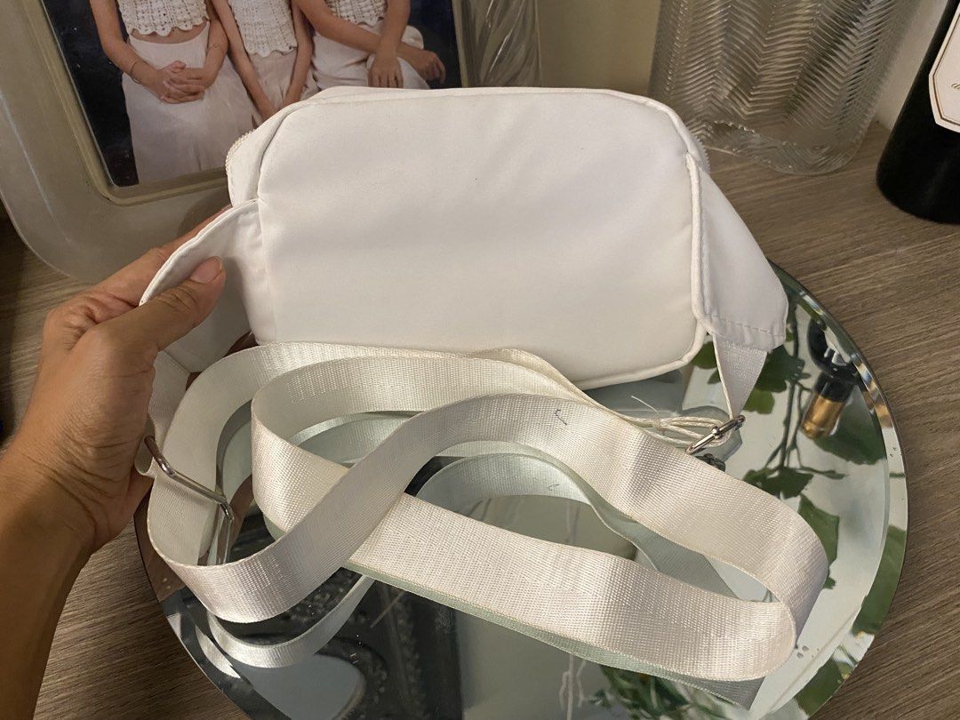 White Nylon Crossbody Bag with Adjustable Strap (Category: Cross-body Bags) located in Santa Rosa. Submitted by hoardqueensdeclutter (Listing ID 1462888643, Image 2). Description: - Stylish white nylon crossbody bag - Zippered main compartment for secure storage - Additional front zip pocket for quick access - Adjustable nylon webbing strap for a custom fit - Perfect for carrying essentials hands-free - Durable and easy-to-clean material.
