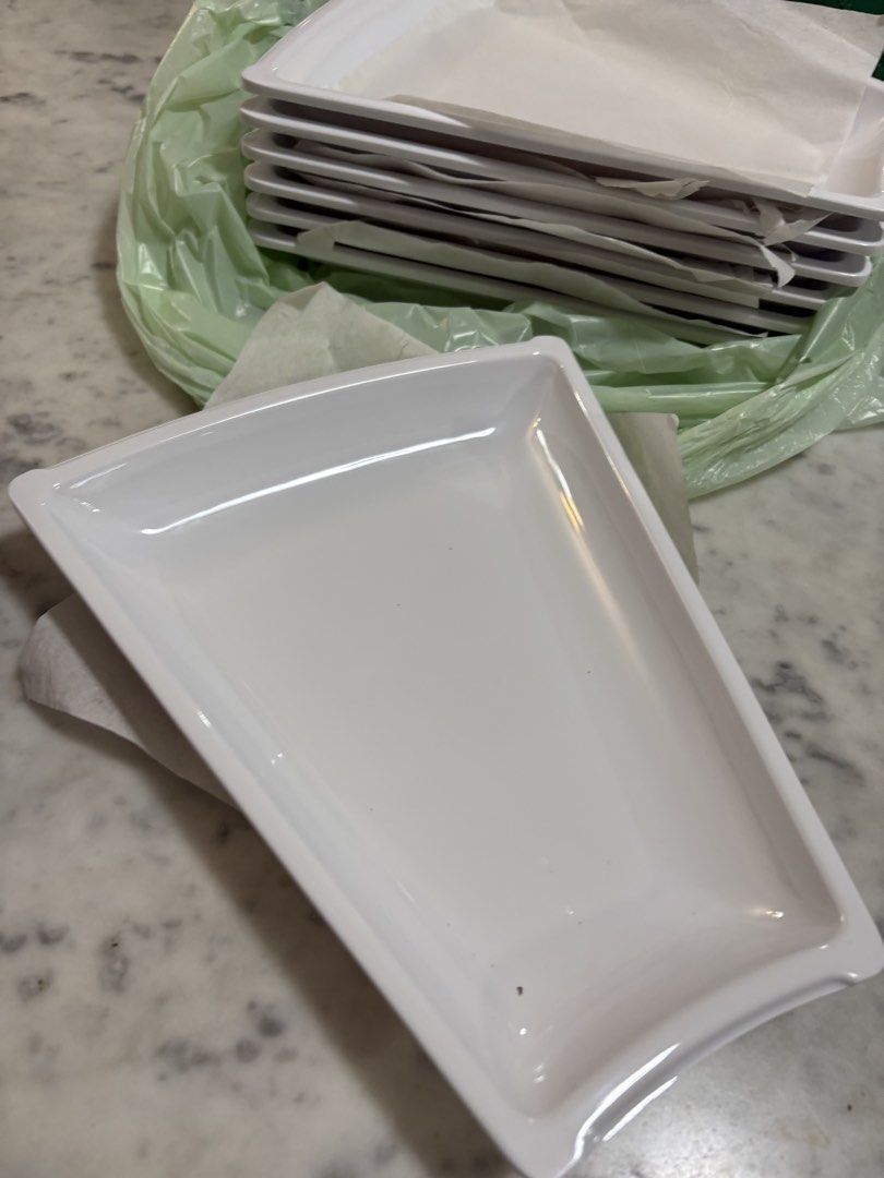 White Rectangular Serving Trays Set (Category: Dinnerware & Cutlery) located in Singapore. Submitted by mitokomon (Listing ID 1463025355, Image 1). Description: - White rectangular serving trays size 20x10x25 cm - Stackable design for easy storage - Ideal for parties, snacks, or desserts - Features slightly curved brand new , we have too many 3.5 $ for all 7 trays.