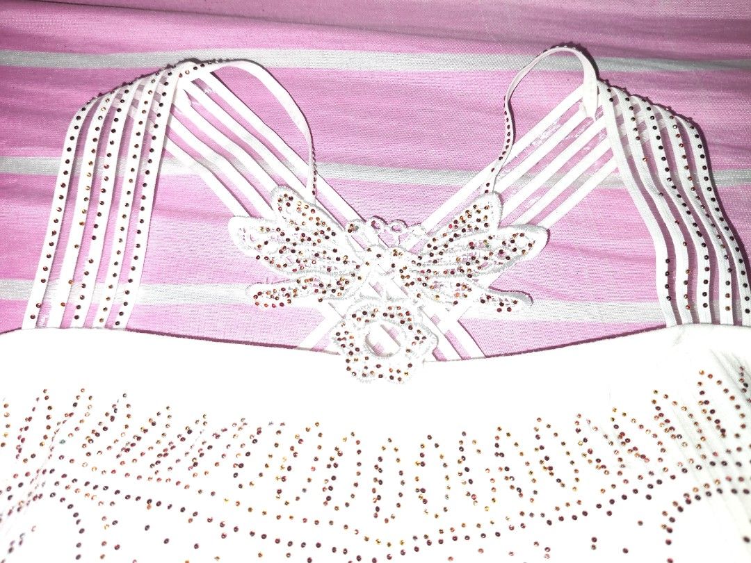 White Rhinestone Butterfly Halter Tank Top (Category: Sleeveless) located in Manila. Submitted by pink_orchidd (Listing ID 1463090394, Image 3). Description: - White halter top - Sparkly rhinestone pattern on front - Criss-cross back straps with butterfly embellishment.