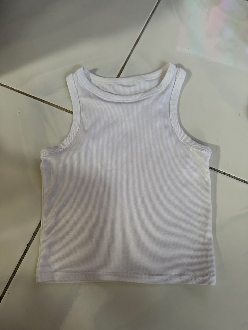 White Ribbed Tank Top (Category: Sleeveless) located in Caloocan City. Submitted by triciacab (Listing ID 1462935846, Image 1). Description: - Basic white ribbed tank top - High neckline, sleeveless design - Stretchy and comfortable material - Versatile for layering or wearing on its own - Effortlessly matches any outfit - A must-have staple piece for your wardrobe.