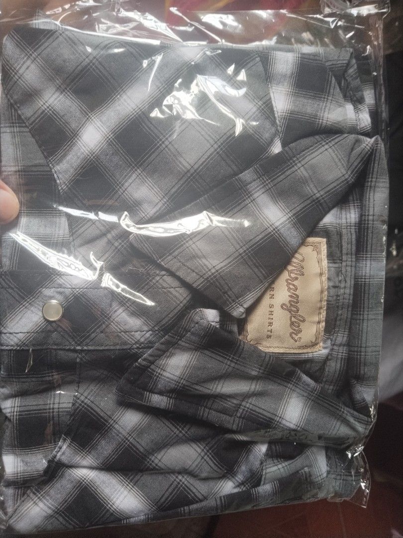 Wrangler Plaid Western Shirt (Category: Tshirts & Polo Shirts ) located in Manila. Submitted by juanayesha1713 (Listing ID 1462959213, Image 1). Description: - Classic plaid western shirt by Wrangler - Features convenient snap button closure - Comfortable textured fabric - Versatile for casual wear or layering - Offers a sharp and stylish appearance.