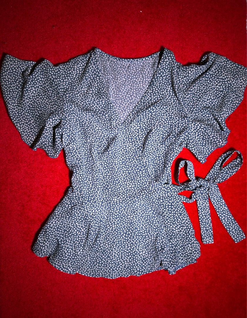 Wrap Top with Tie (Category: Blouses) located in Makati City. Submitted by ydeolch (Listing ID 1463086116, Image 1). Description: Sweet, feminine, and effortlessly pretty in a lovely blue and white print. 💙🤍 ✿ Size: Small (S) ✿ Condition: Used Once ✿ Color: Blue & White ✿ Charming short flutter sleeves ✿ Convenient side tie for an adjustable fit ✿ Flattering peplum hem ✿ Wrap-style design 💌 Message me for measurements 📌 RFS: Decluttering 📌 C