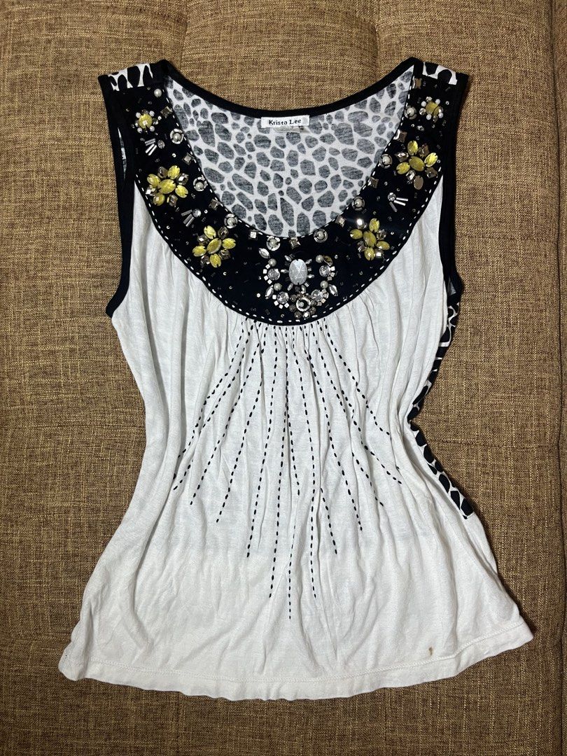 Y2k Embellished Sleeveless (Category: Sleeveless) located in Mexico. Submitted by drei_declutter (Listing ID 1462887476, Image 1). Description: - Krista Lee Sleeveless Top - Size: Medium (M) - Color: White with Black Trim - Design: Bold animal print on back and neckline - Embellishments: Rhinestones and beads on neckline - Front Detail: Dainty dotted lines - Back Hem: Decorative black print.