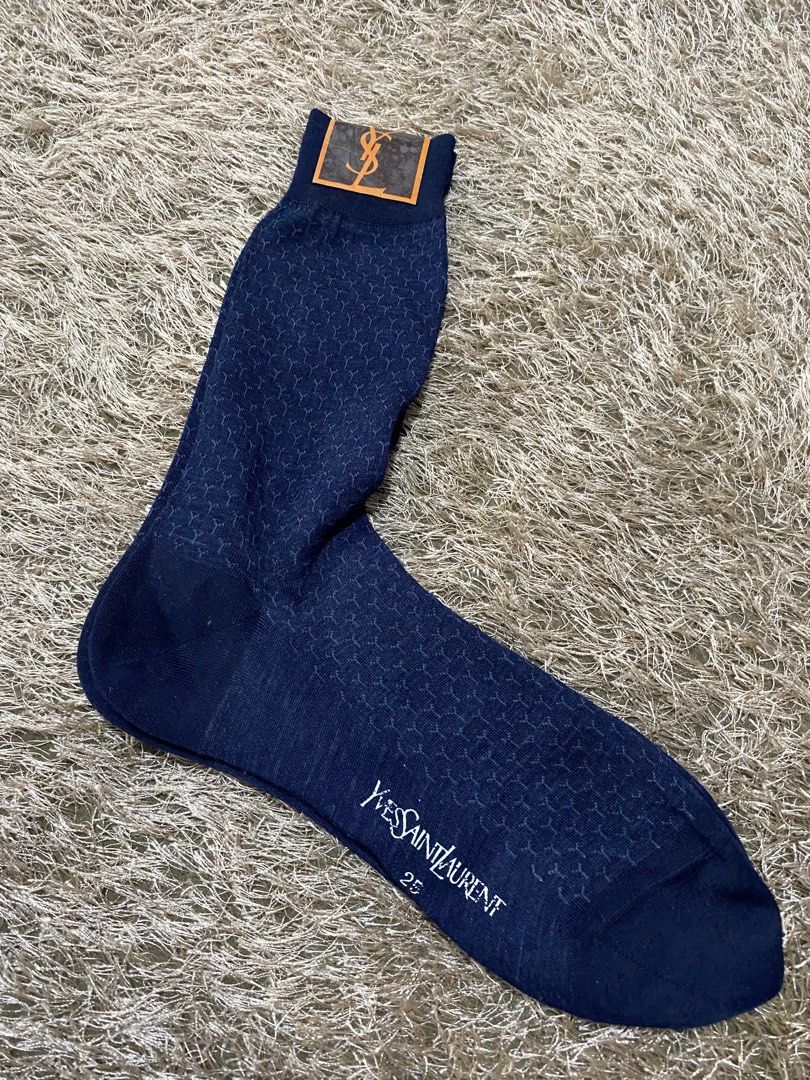 Yves Saint Laurent Navy Blue Patterned Socks (Category: Socks) located in Bulacan. Submitted by rich2545 (Listing ID 1462900858, Image 1). Description: - Brand: Yves Saint Laurent (YSL) - Color: Navy Blue - Design: Subtle all-over geometric pattern - Logo: YSL logo on tag - Size: 25 - Versatile: Suitable for everyday wear or dressing up.