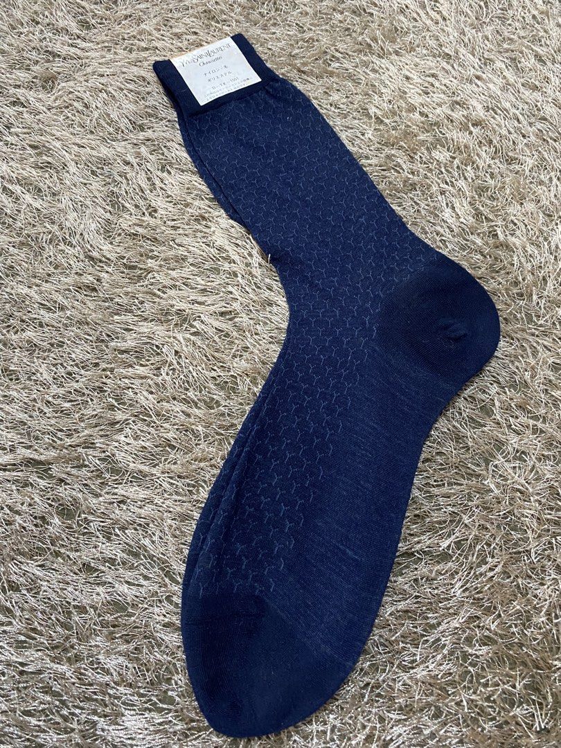 Yves Saint Laurent Navy Blue Patterned Socks (Category: Socks) located in Bulacan. Submitted by rich2545 (Listing ID 1462900858, Image 2). Description: - Brand: Yves Saint Laurent (YSL) - Color: Navy Blue - Design: Subtle all-over geometric pattern - Logo: YSL logo on tag - Size: 25 - Versatile: Suitable for everyday wear or dressing up.