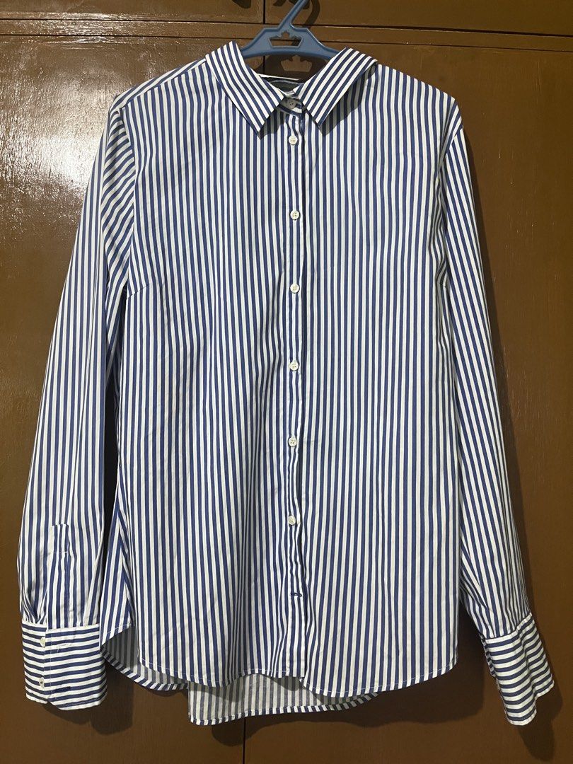 Zara Basic Striped Button-Up Shirt (Category: Longsleeves) located in Pasig City. Submitted by instawardrobe (Listing ID 1463025461, Image 1). Description: - Classic blue stripes - Zara Basic button-up shirt - Long sleeves with buttoned cuffs - Button-down front - Versatile for work or casual outfits - Made in Morocco - Size L.