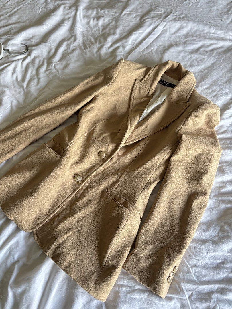 Zara Beige coat (Category: Coats, Jackets and Outerwear) located in Manila. Submitted by michaela17_ (Listing ID 1462930225, Image 1). Description: - Classic beige blazer from Zara - Front flap pockets - Button details on cuffs - Perfect for dressing up or down Rfs: Upgrade issue: hole in the pocket.