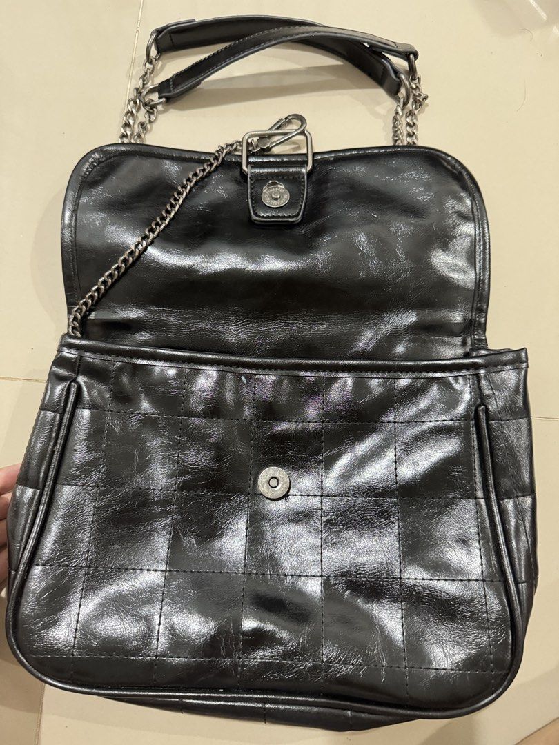 Zara Black Quilted Chain Shoulder Bag (Category: Shoulder Bags) located in Bacolod City. Submitted by matahum.bcd (Listing ID 1463058559, Image 2). Description: - Zara black shoulder bag - All-over quilted pattern - Silver chain strap - Magnetic snap closure - Interior zippered pocket - Versatile for everyday or evening wear.