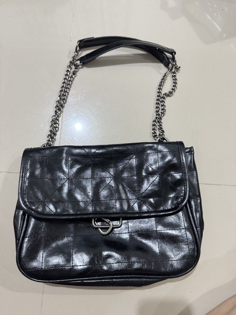 Zara Black Quilted Chain Shoulder Bag (Category: Shoulder Bags) located in Bacolod City. Submitted by matahum.bcd (Listing ID 1463058559, Image 1). Description: - Zara black shoulder bag - All-over quilted pattern - Silver chain strap - Magnetic snap closure - Interior zippered pocket - Versatile for everyday or evening wear.