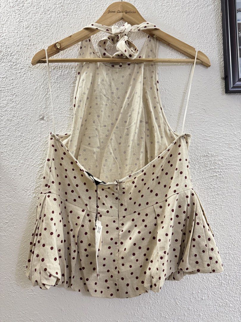 Zara Polka Dot Halter Neck Top with Tie Back (Category: Sleeveless) located in Manila. Submitted by janelica220598 (Listing ID 1462896801, Image 2). Description: - Cute beige top with dark red polka dots - Halter neck with tie-back closure - Peplum hem with gathered detail - Zipper closure at the back - Versatile for casual or night out looks.