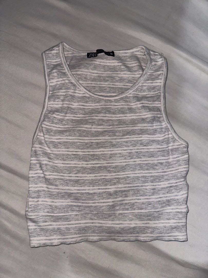 Zara Striped Ribbed Crop Tank Top (Category: Sleeveless) located in Manila. Submitted by etain.xo (Listing ID 1463027821, Image 1). Description: - Zara grey and white striped ribbed crop tank top - Sleeveless design with a rounded neckline - Stretchy material for a comfortable fit - Versatile for layering or wearing on its own - Fits xxs to s.