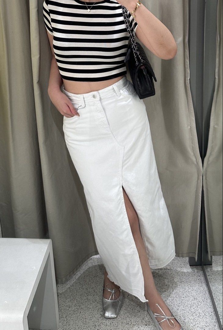 Zara White Denim Skirt (Category: Skirts) located in Manila. Submitted by shopelisse (Listing ID 1463030704, Image 1). Description: - White denim maxi skirt - Features a front slit for easy movement - High-waisted style - Versatile piece for casual outings or dressing up.
