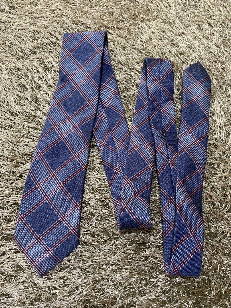 Ziozia Blue Plaid Necktie (Category: Ties) located in Bulacan. Submitted by rich2545 (Listing ID 1462901765, Image 1). Description: - Classic blue necktie by Ziozia - Features a red and white plaid pattern - Versatile for both formal and casual occasions - Adds a stylish touch to any outfit.