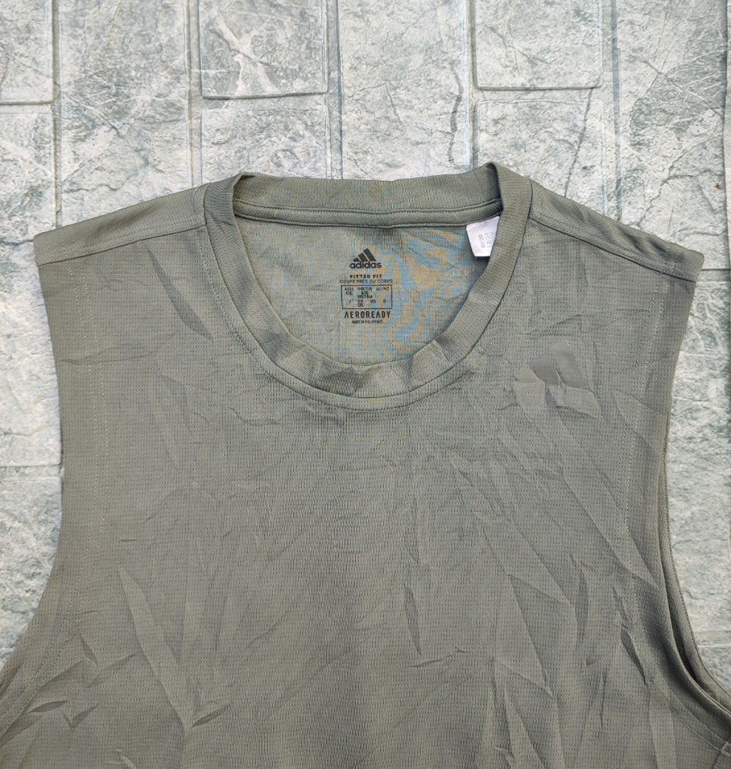 Adidas Aeroready Tank Top (Category: Activewear) located in Bayambang. Submitted by mon10192816 (Listing ID 1463326228, Image 3). Description: - Width 19¾ - Length 27.5 - Issue Cut wash tag - Adidas tank top in muted green - Made with breathable Aeroready material - Sleeveless design for comfort - Perfect for workouts or everyday casual wear.