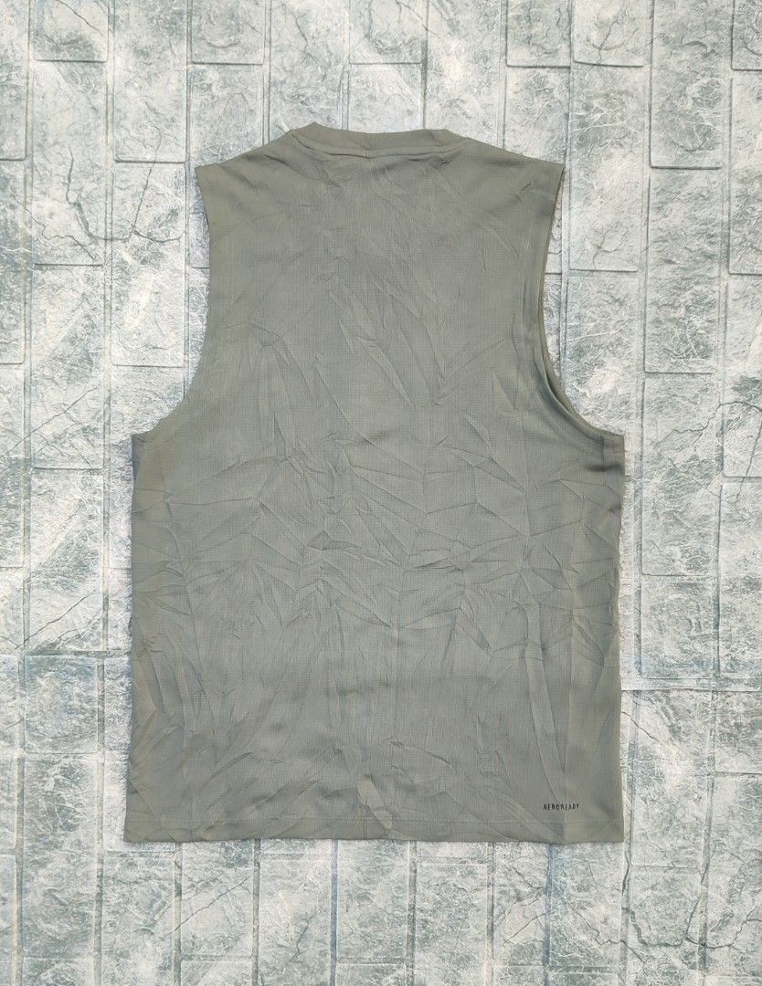 Adidas Aeroready Tank Top (Category: Activewear) located in Bayambang. Submitted by mon10192816 (Listing ID 1463326228, Image 2). Description: - Width 19¾ - Length 27.5 - Issue Cut wash tag - Adidas tank top in muted green - Made with breathable Aeroready material - Sleeveless design for comfort - Perfect for workouts or everyday casual wear.