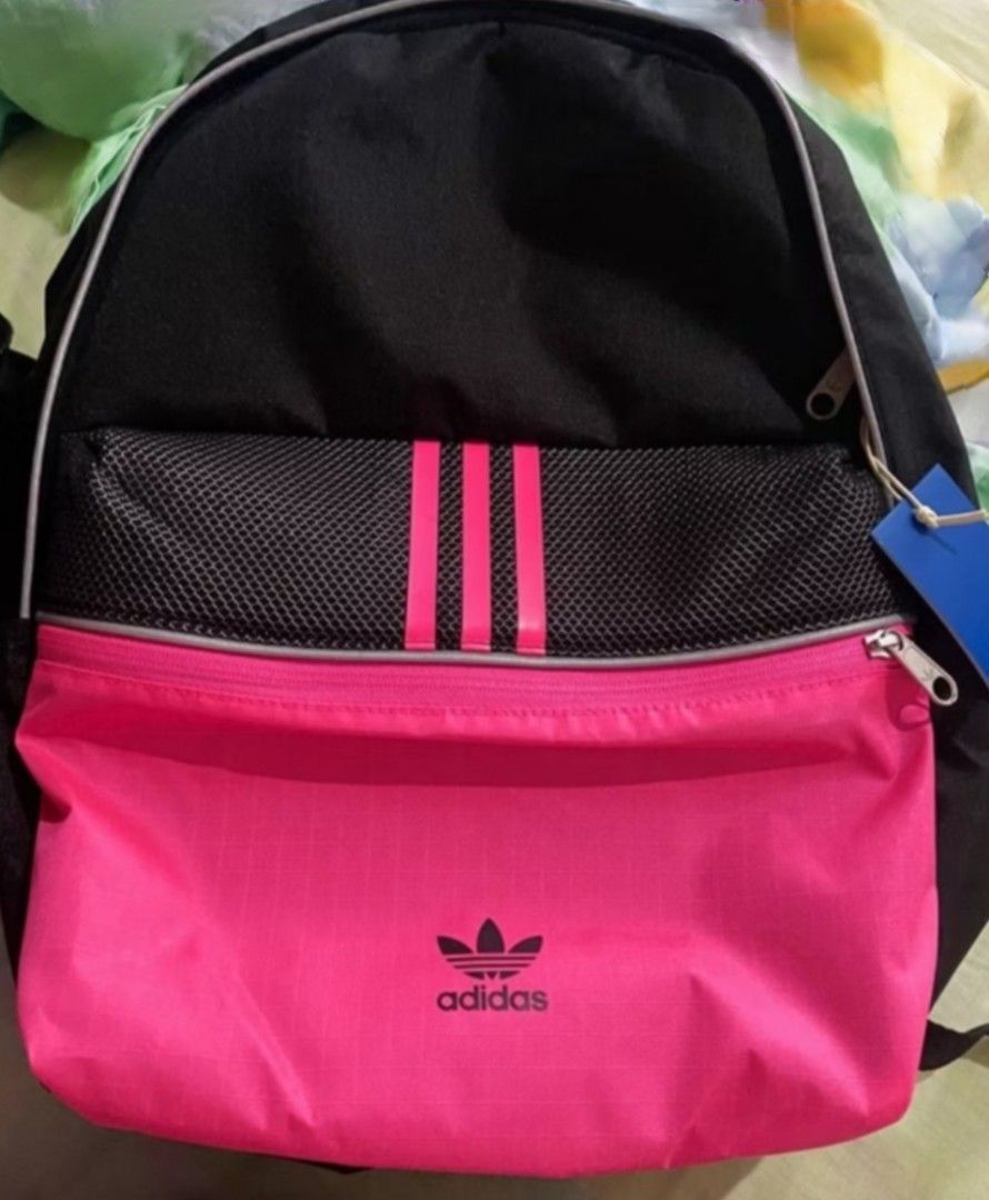Adidas Backpack Black Pink Trefoil Logo (Category: Backpacks) located in Manila. Submitted by hannsjewels (Listing ID 1463222358, Image 2). Description: - Brand new Adidas backpack - Bright pink front pocket - Classic three stripes and trefoil logo - Mesh detail on the front orig price Php 2700 measurements: height 17 inch width 13 inch reflectorized other photo (not mine) for reference only. - Padded straps for comfort - Ideal for school or ever