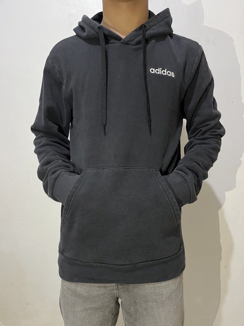 Adidas Essentials Small Logo Fleece Pullover Hoodie (Category: Hoodies) located in Manila. Submitted by chanie836 (Listing ID 1463262171, Image 3). Description: - Classic black Adidas hoodie - Features a clean white logo on the chest - Convenient front pocket - Adjustable drawstring hood - Tagged A/XS, S, 170/88A (Made in Indonesia) - Ideal for everyday casual wear.