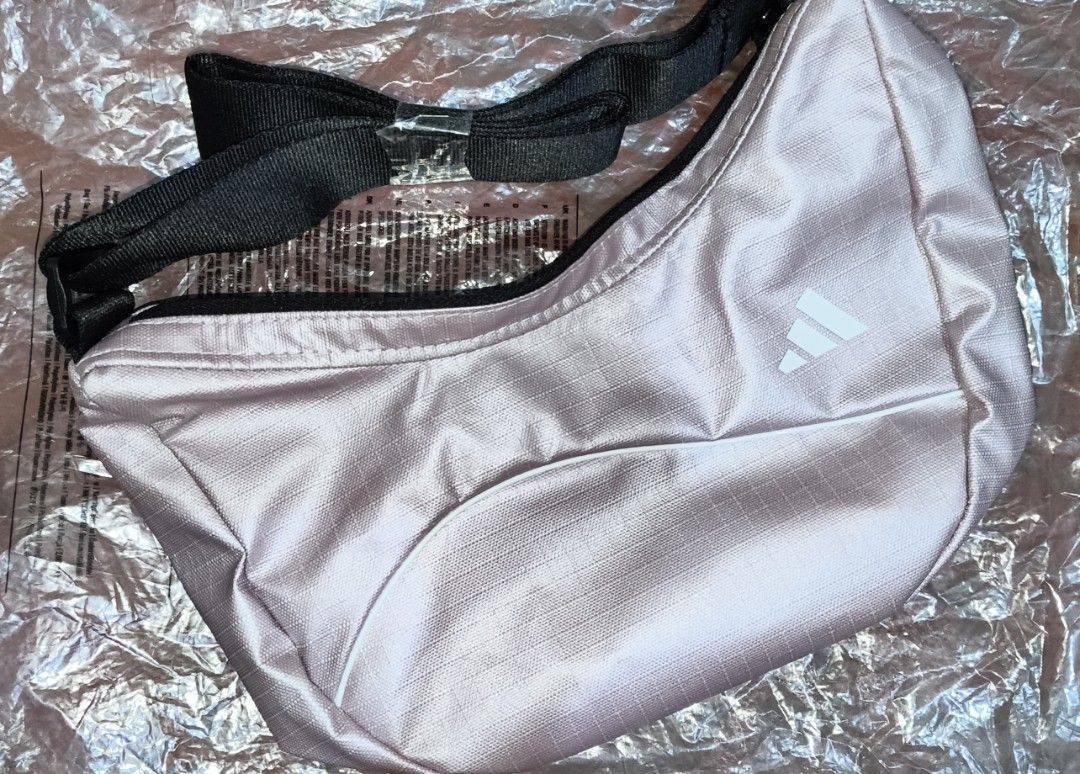 Adidas Pink Crossbody Bag (Category: Cross-body Bags) located in Manila. Submitted by yahs04 (Listing ID 1463240455, Image 1). Description: - Pink Adidas crossbody bag - Main zippered compartment - Adjustable strap - Ideal for everyday use or travel - Lightweight and easy to carry - Features the iconic Adidas logo on the front.