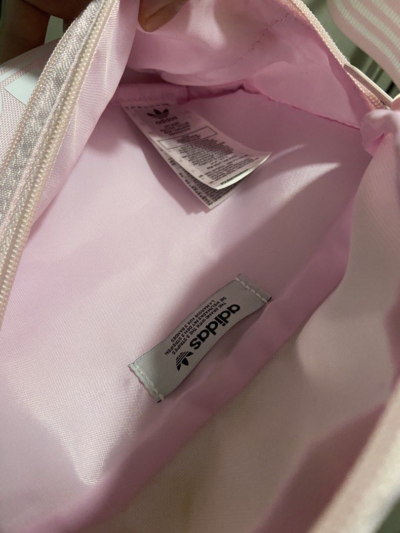 Adidas Pink Fanny Pack (Category: Purses & Pouches) located in Quezon City. Submitted by densyaaa12 (Listing ID 1463189525, Image 2). Description: Never been used. - Cute pink Adidas fanny pack - Two zippered compartments - Adjustable strap with classic Adidas stripes - Ideal for carrying your essentials.