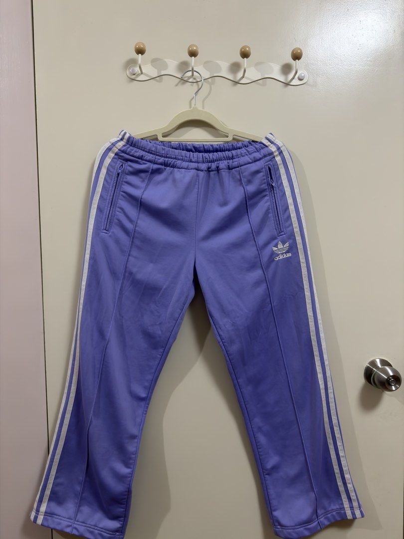 Adidas Track Pants (Category: Other Bottoms) located in Manila. Submitted by lily.e0630 (Listing ID 1463287755, Image 1). Description: - Classic purple Adidas track pants - Can fit small-medium - Comfortable elastic waistband with adjustable drawstring - Two convenient zippered pockets at the front - Ideal for everyday casual wear or athletic activities.