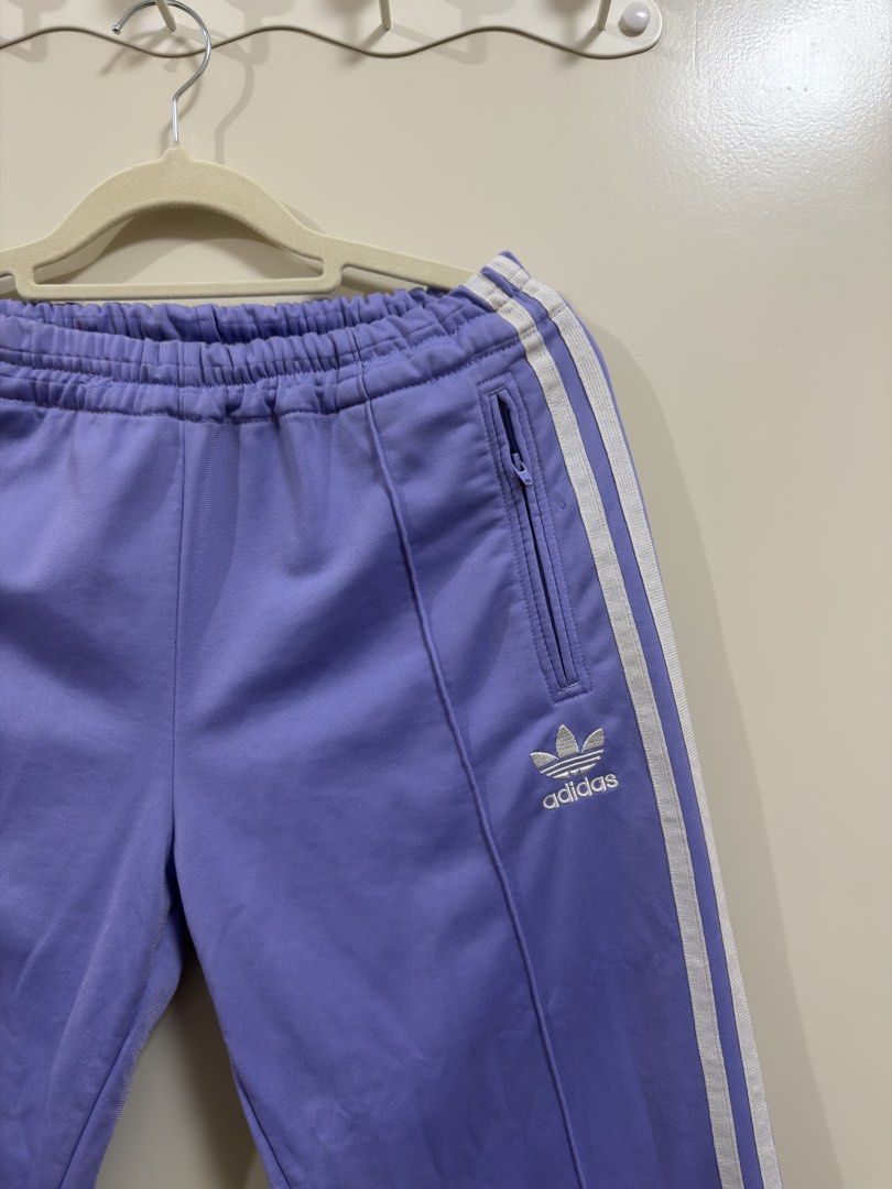 Adidas Track Pants (Category: Other Bottoms) located in Manila. Submitted by lily.e0630 (Listing ID 1463287755, Image 2). Description: - Classic purple Adidas track pants - Can fit small-medium - Comfortable elastic waistband with adjustable drawstring - Two convenient zippered pockets at the front - Ideal for everyday casual wear or athletic activities.