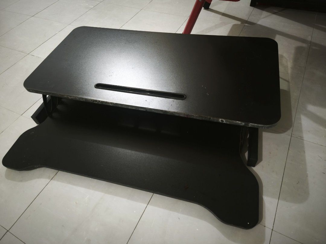 Adjustable Standing Desk Converter Workstation Riser (Category: Office Furniture & Fixtures) located in Caloocan City. Submitted by yennarz (Listing ID 1463197775, Image 1). Description: 3 years old, still works great and rises up smoothly. Can be used for desktop screen and keyboard. Visible scratches from use. For delivery via Lalamove Sedan only. 80 cm W, 45 cm L, 49cm H (fully extended).