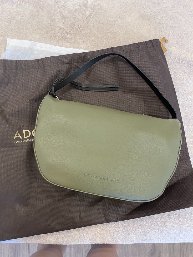 Adolfo Dominguez Green Leather Shoulder Bag (Category: Shoulder Bags) located in Muntinlupa City. Submitted by annalau19 (Listing ID 1463197774, Image 1). Description: - Adolfo Dominguez shoulder bag - Chic green color - Features a stylish black strap - Comes with original dust bag - Ideal for everyday wear.