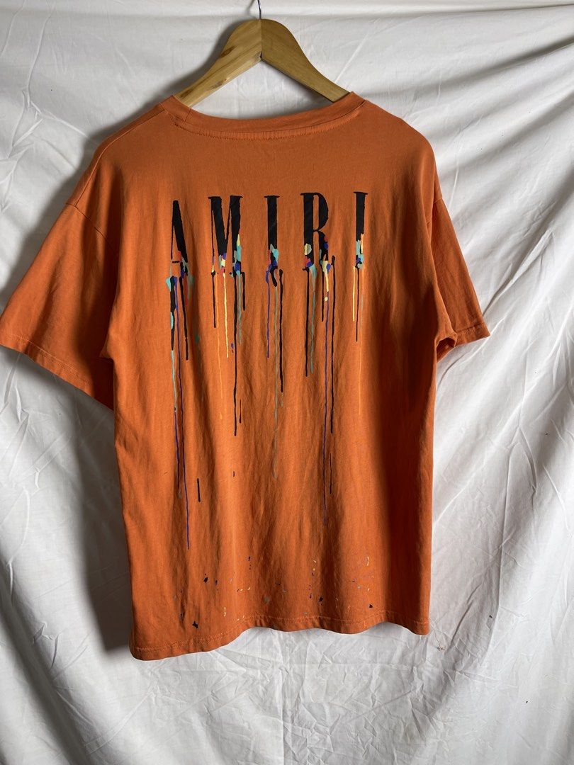 AMIRI Orange Drip Logo T-Shirt (Category: Tshirts & Polo Shirts ) located in Manila. Submitted by noahcastilljos363 (Listing ID 1463211754, Image 3). Description: - Orange AMIRI T-shirt - Signature drip logo on front and back - Made from a comfortable cotton blend - Ideal for casual outfits.