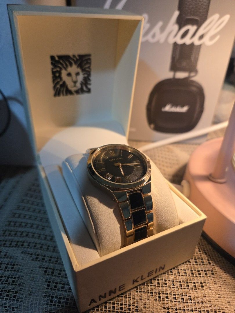Anne Klein (Category: Women's Watches) located in Manila. Submitted by AA8888 (Listing ID 1463182922, Image 2). Description: - Elegant Gold and Black Anne Klein Watch - Classic design featuring Roman numerals on the face - Includes original box - Versatile for both everyday wear and special occasions - A truly timeless accessory Pick up or lalamove .