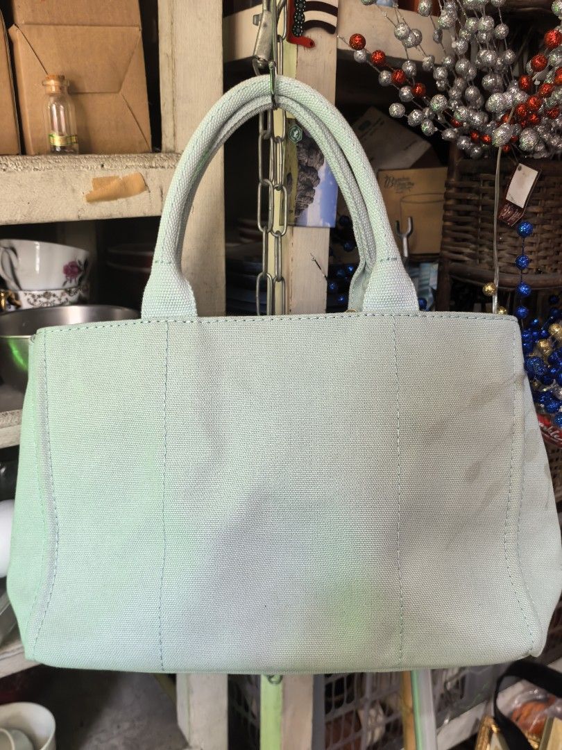 Anteprima Misto Light Blue Canvas Tote Bag (Category: Tote Bags) located in Rizal. Submitted by gkstcenit (Listing ID 1463237049, Image 3). Description: - Anteprima Misto tote bag - Light blue canvas material - Gold tone hardware - Zipper closure - Interior zipped pocket - Interior slip pocket - Small bow charm attached to handle - Ideal for everyday use.