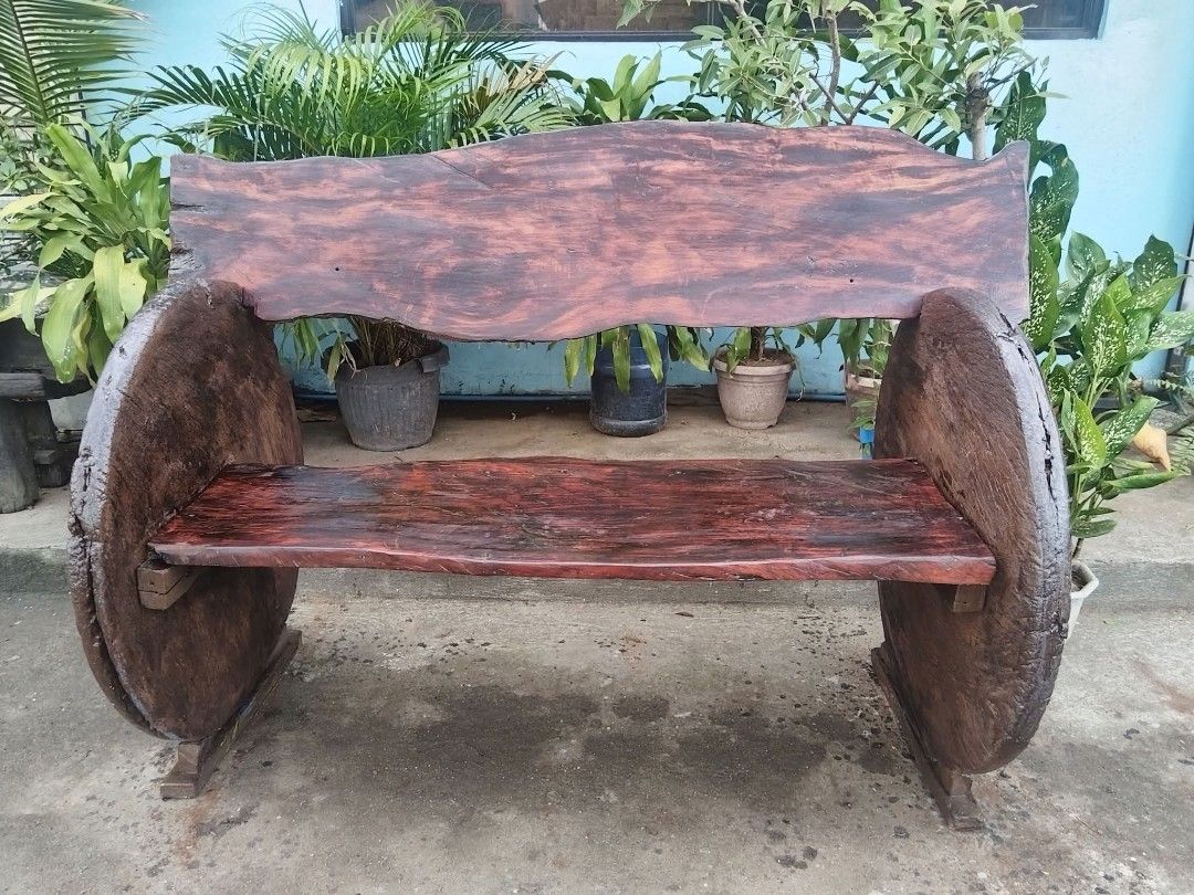 Antique Rustic Bench (Category: Other Home Furniture) located in Meycauayan. Submitted by marygracecasimiro (Listing ID 1463186485, Image 1). Description: Premium Antique Rustic Bench made of Red Narra Wood and Molave Wood (wheels), side wheels are salvaged from antique wooden carriages (gulong na kahoy). In excellent condition. Revarnished. Ready to use. Get it for only P50,000 Need atleast 6 person to lift. Size L61 x W32 x SH21 x H34 inches ♥️
