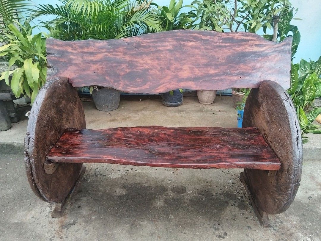 Antique Rustic Bench (Category: Other Home Furniture) located in Meycauayan. Submitted by marygracecasimiro (Listing ID 1463186485, Image 2). Description: Premium Antique Rustic Bench made of Red Narra Wood and Molave Wood (wheels), side wheels are salvaged from antique wooden carriages (gulong na kahoy). In excellent condition. Revarnished. Ready to use. Get it for only P50,000 Need atleast 6 person to lift. Size L61 x W32 x SH21 x H34 inches ♥️