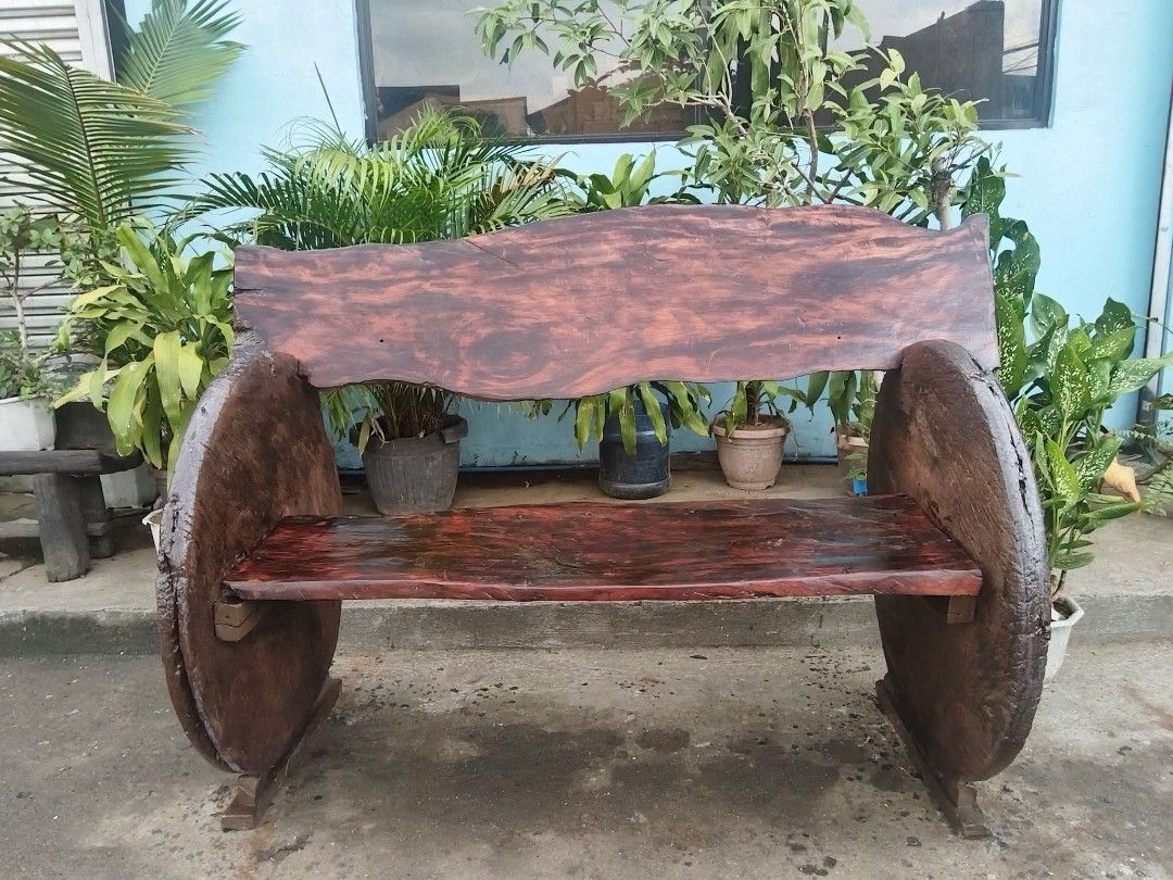 Antique Rustic Bench (Category: Other Home Furniture) located in Meycauayan. Submitted by marygracecasimiro (Listing ID 1463186485, Image 3). Description: Premium Antique Rustic Bench made of Red Narra Wood and Molave Wood (wheels), side wheels are salvaged from antique wooden carriages (gulong na kahoy). In excellent condition. Revarnished. Ready to use. Get it for only P50,000 Need atleast 6 person to lift. Size L61 x W32 x SH21 x H34 inches ♥️