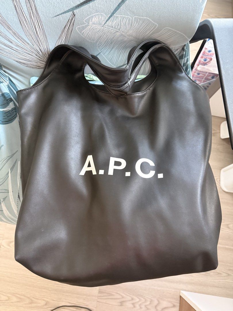 A.P.C. Ninon Black Leather Tote Bag (Category: Tote Bags) located in Quezon City. Submitted by charmerchant (Listing ID 1463222277, Image 1). Description: - Brand: A.P.C. - Material: Black Leather - Style: Tote Bag Black Large size With minor peeling on shoulder straps but not very visible especially when worn.